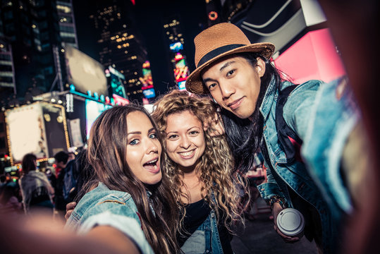 Friends taking selfie in Times Square
