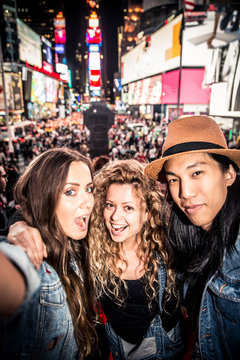 Friends taking selfie in Times Square