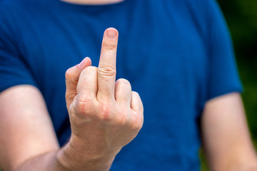 Young male person showing his middle finger