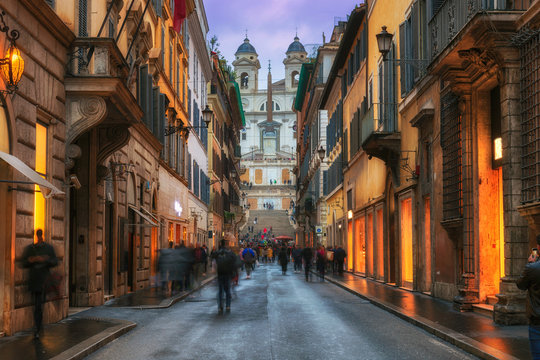 Fototapeta Evening view of old cozy street near Spanish Steps in Rome, Italy. Architecture and landmark of Rome. Night cityscape of Rome.