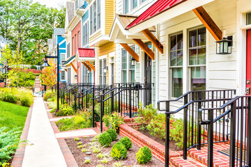 Row of colorful, red, yellow, blue, white, green painted residential townhouses, homes, houses with...