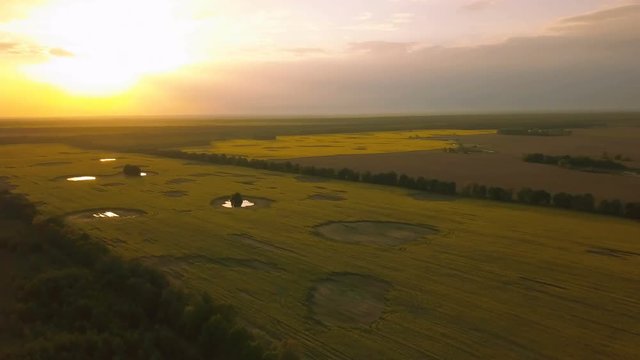 4k.Aerial. Landscape with fields and beautiful  color sky  in sunset time