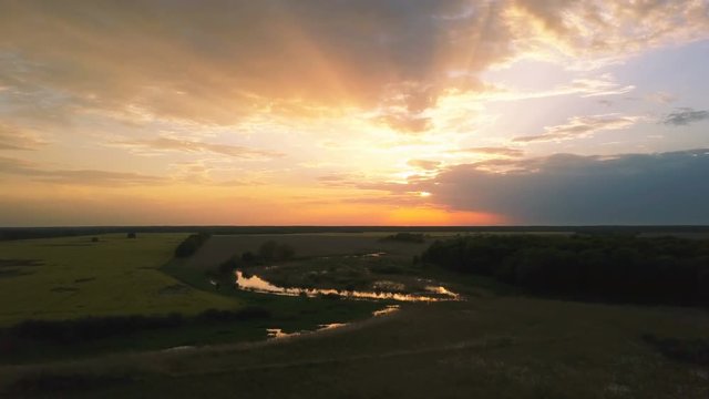 4k.Aerial. Landscape with fields and beautiful  color sky  in sunset time