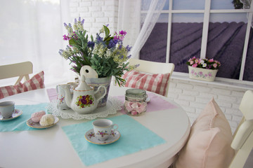 Table setting. Tea drinking. Interior in light colors. Feast