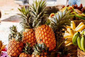 Pineapple fruit on wood table for sale.