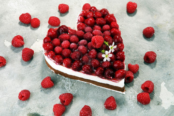raspberry cake and many fresh raspberries.