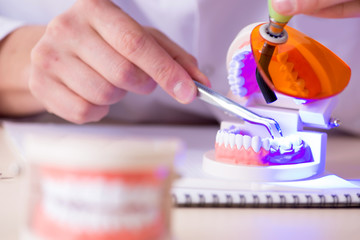 Fototapeta na wymiar Dentist working teeth implant in medical lab