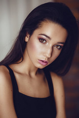Naklejka premium Portrait of beautiful young brunette woman with makeup