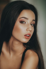 Obraz premium Portrait of beautiful young brunette woman with makeup