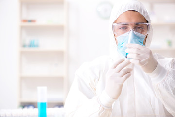 Young chemist student working in lab on chemicals