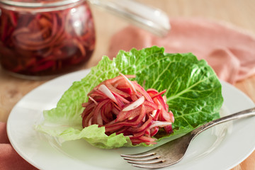 Pickled red onions in a glass jar