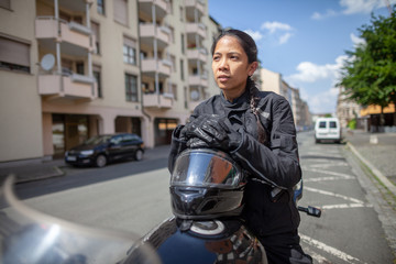 Woman with a black helmet on a motorbike