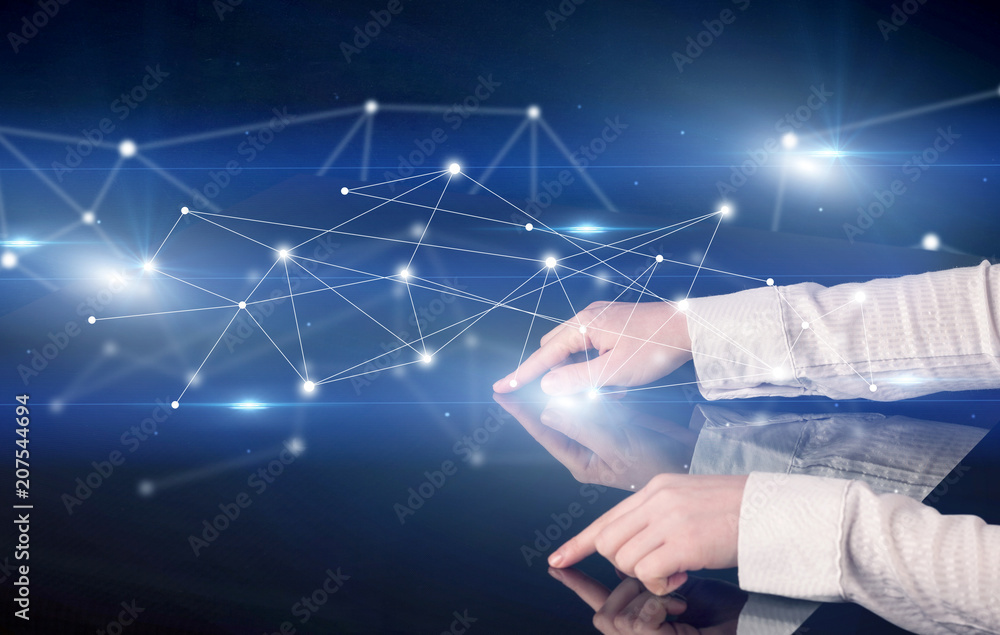 Poster male hands touching interactive table with blue connectivity graphic in the background