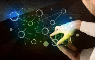 Male hands touching interactive table with colorful world map on it 