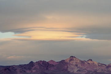 Naklejka na ściany i meble Morning lenticular clouds in the Mojave Desert in California.