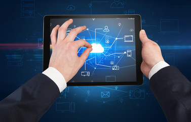 First person view of a hand using tablet with cloud office concept
