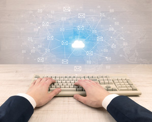 First person view of an elegant businessman hand  typing with connected mails concept
