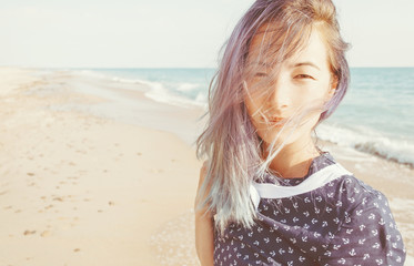 Portrait of mixed race woman on beach.