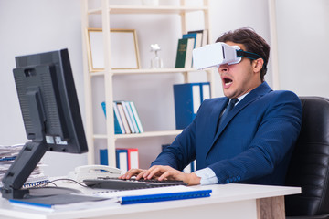 Employee using virtual reality glasses in office