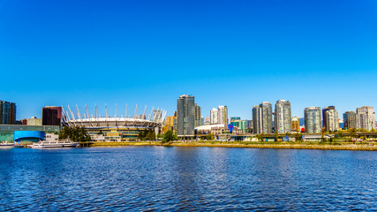 Naklejka premium Skyline of the City of Vancouver, British Columbia, Canada as seen from the False Creek Inlet on a clear summer day