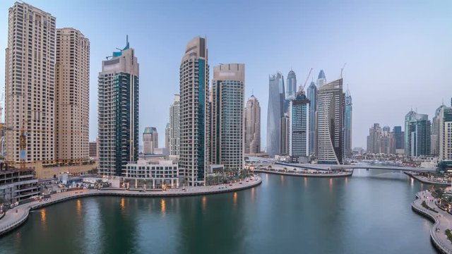 Beautiful aerial top view day to night transition timelapse of Dubai Marina canal