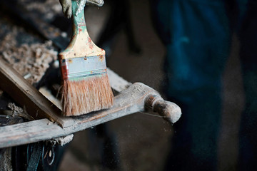 brush process from gunpowder and web, wood planer and shavings at carpenters workshop, old woodworking tool, sawdust, antique saws. selective focus