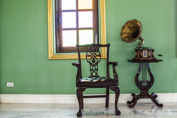 Antique record player and a chair in the corner.