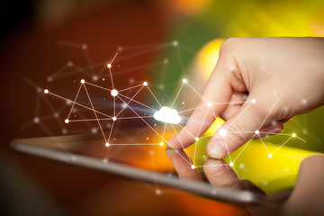 Female hands touching tablet with white cloud concept