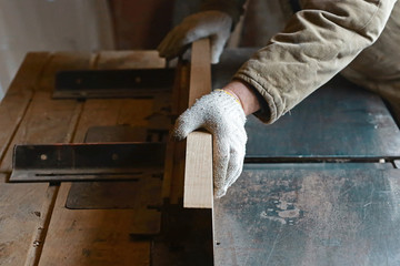 Close Up carpenter process of wood processing on the machine, planting an oak board. selective focus