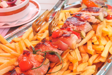 Tasty grilled meat on fries