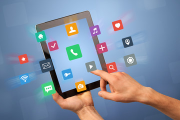 Female fingers touching tablet with colorful applications