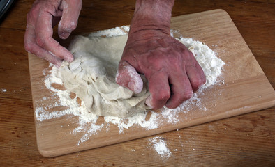 Baker preparing some dough ready to bake some bread