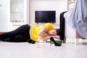 Man with mess at home after house party