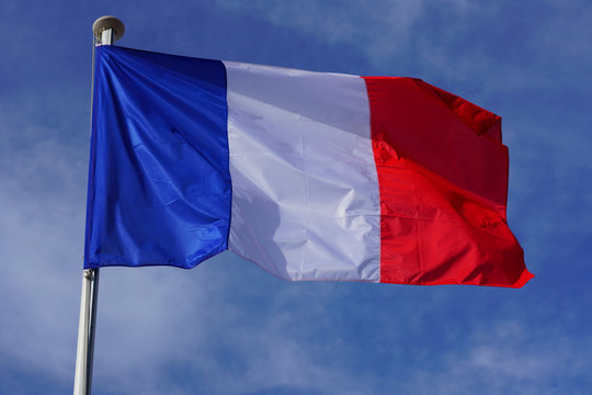 A French flag with blue, white and red stripes