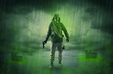 Fototapeta premium Masked unrecognizable guard in an abandoned space after explosion 