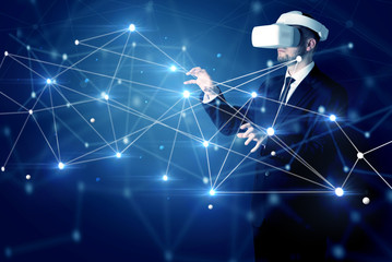 Businessman in virtual reality goggles investigate global network connectivity concept
