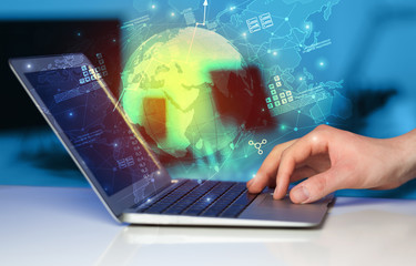 Hand using laptop with global reports and stock market change concept
