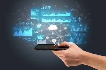 Businessman using phone with flying application icons around
