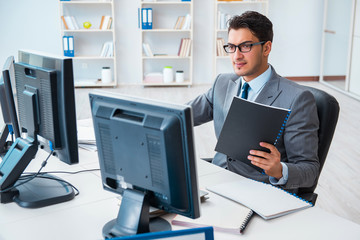 Fototapeta premium Businessman sitting in front of many screens