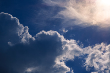 Dramatic sky with clouds and sun from behind the clouds.
