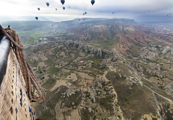 Fototapeta na wymiar A balloons is flying over the valley in Cappadocia