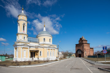 Fototapeta na wymiar Kolomna, Russia. Church Of Exaltation Of Cross (Krestovozdvizhenskaya) With Pyatnitsky Gate (Pyatnitskaya Tower) In Kolomna Kremlin.