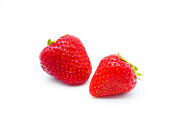 Two whole strawberries isolated on white background
