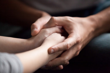 Male hands holding female, caring loving understanding man showing comfort and empathy, giving...