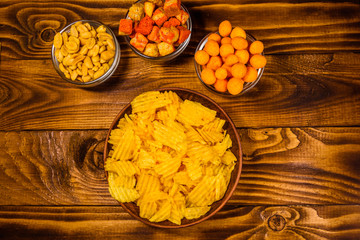 Different snacks for beer on wooden table. Top view