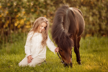 Young girl with her pony