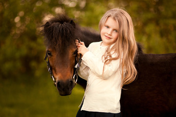 Young girl with her pony