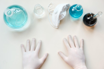 top view of school chemistry lab set with hands