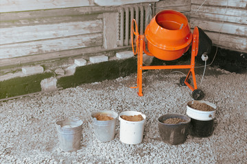 orange concrete mixer for building and repairing a house and ingredients for preparing 