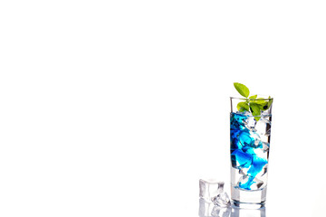 cocktail glass with blue alcoholic drink , close-up isolated on white.